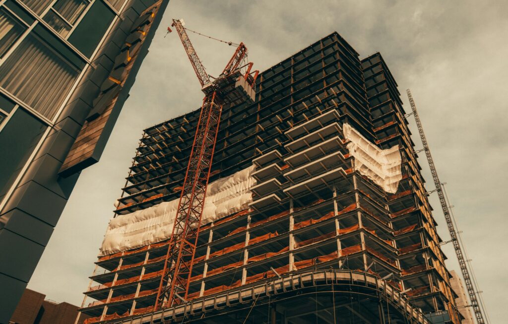 High-rise building under construction with a tower crane